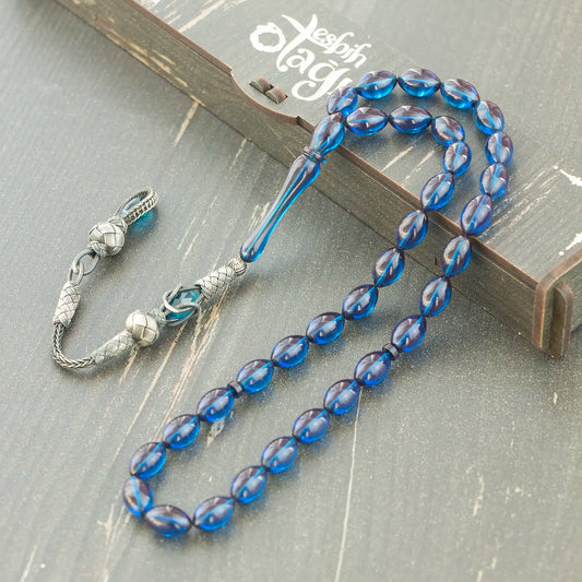 Mavi arpa kesim ateş kehribar tesbih, kazaz püsküllü ve şık tasarımlı model.