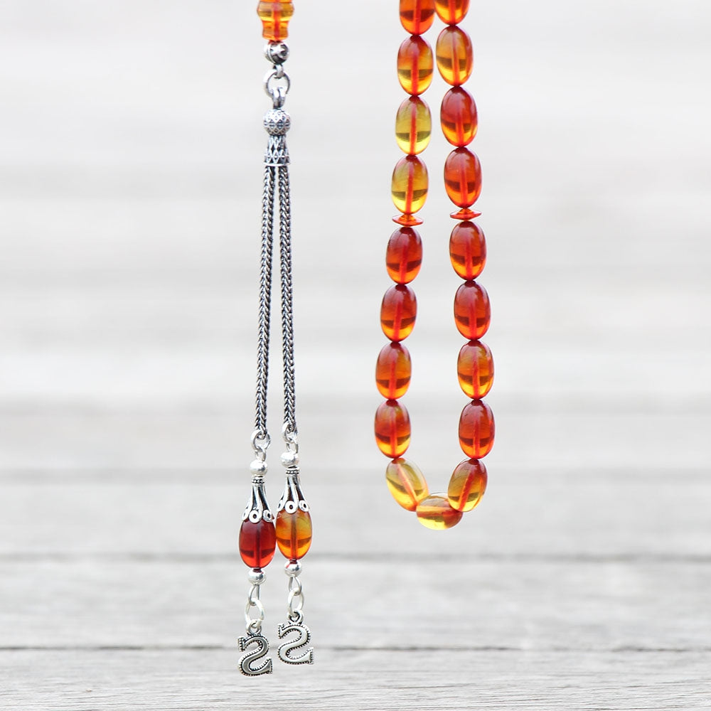 مسبحة إمامي خاصة مطرزة باللون البرتقالي تموج في اللون وكهرماني مع شرابات فضية